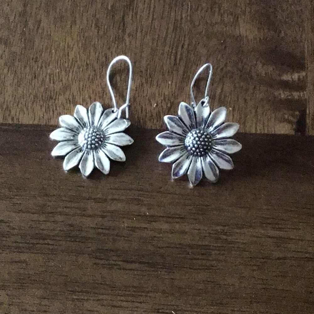 Flower dangle earrings silver in color